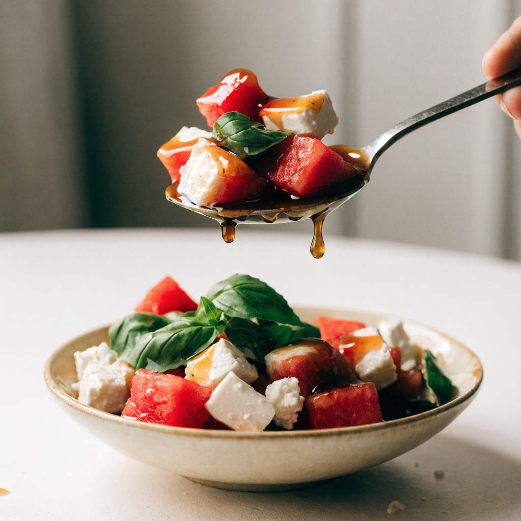 Close-up of chilled watermelon feta salad with honey-balsamic glaze